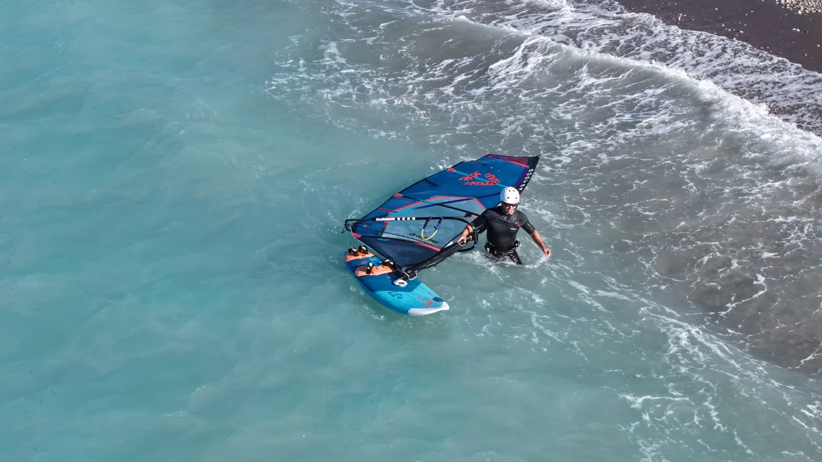 A rider carving a gybe in turquoise water