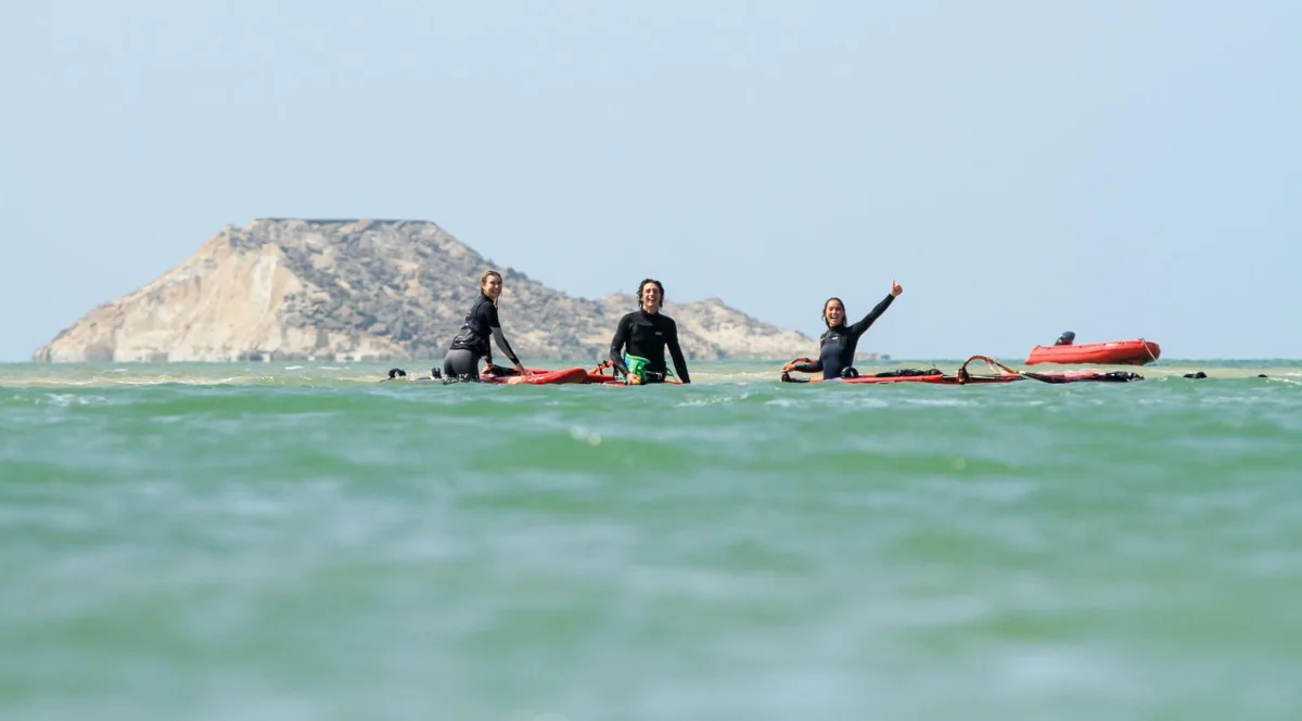 Windsurfers relaxing together on their boards